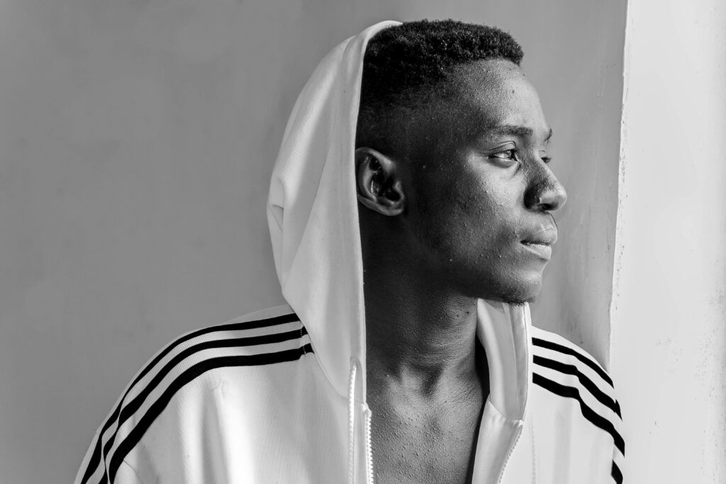pexels-photo-1370750-1370750 Side view monochrome portrait of a man looking thoughtful in a hooded jacket.
