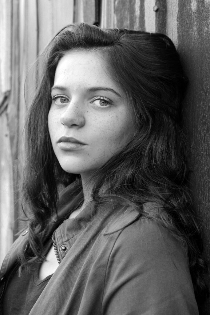 pexels-photo-1499327-1499327 Striking black and white portrait of a young woman with expressive gaze and natural beauty.