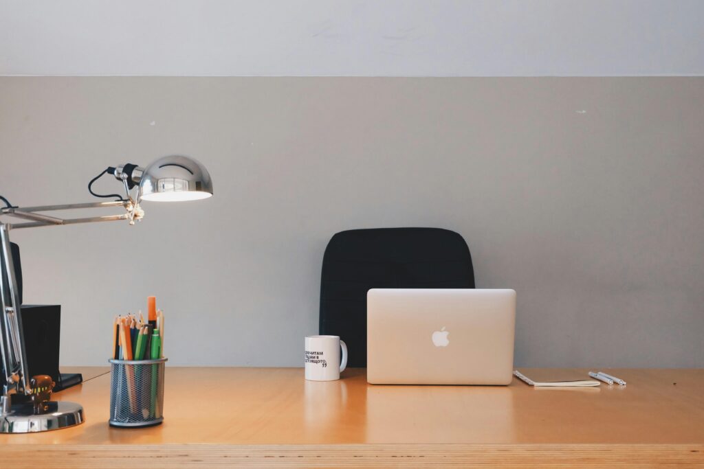 pexels-photo-265072-265072 A tidy minimalist office setup featuring a laptop, desk lamp, and stationery.