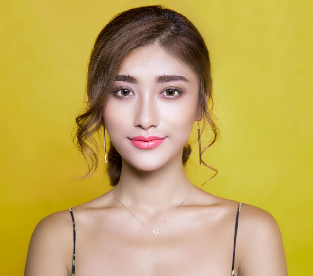pexels-photo-415829-415829 Beautiful portrait of a woman with elegant hairstyle on a vibrant yellow background.