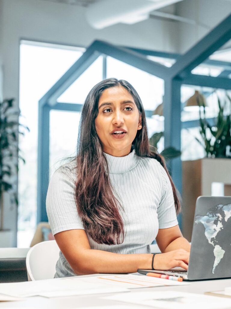 pexels-photo-7688444-7688444 Confident professional woman working at a laptop in a bright modern office.